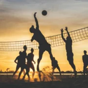 A group of fitness enthusiasts/sports fans playing volleyball.
