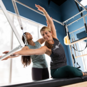 two women doing Pilates on a Cadillac