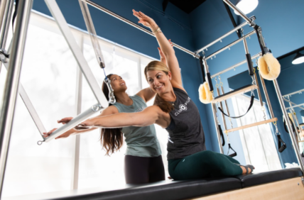 two women doing Pilates on a Cadillac