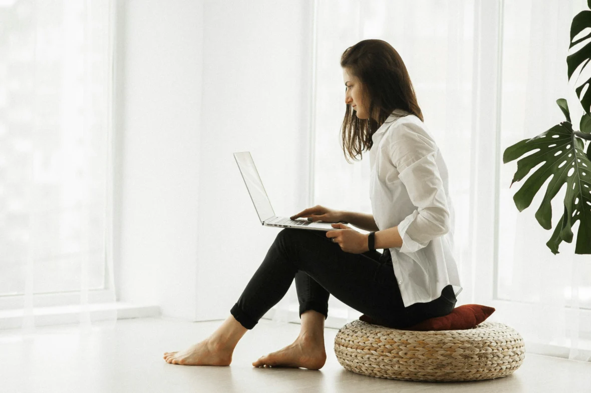 A woman sitting while on her computer.