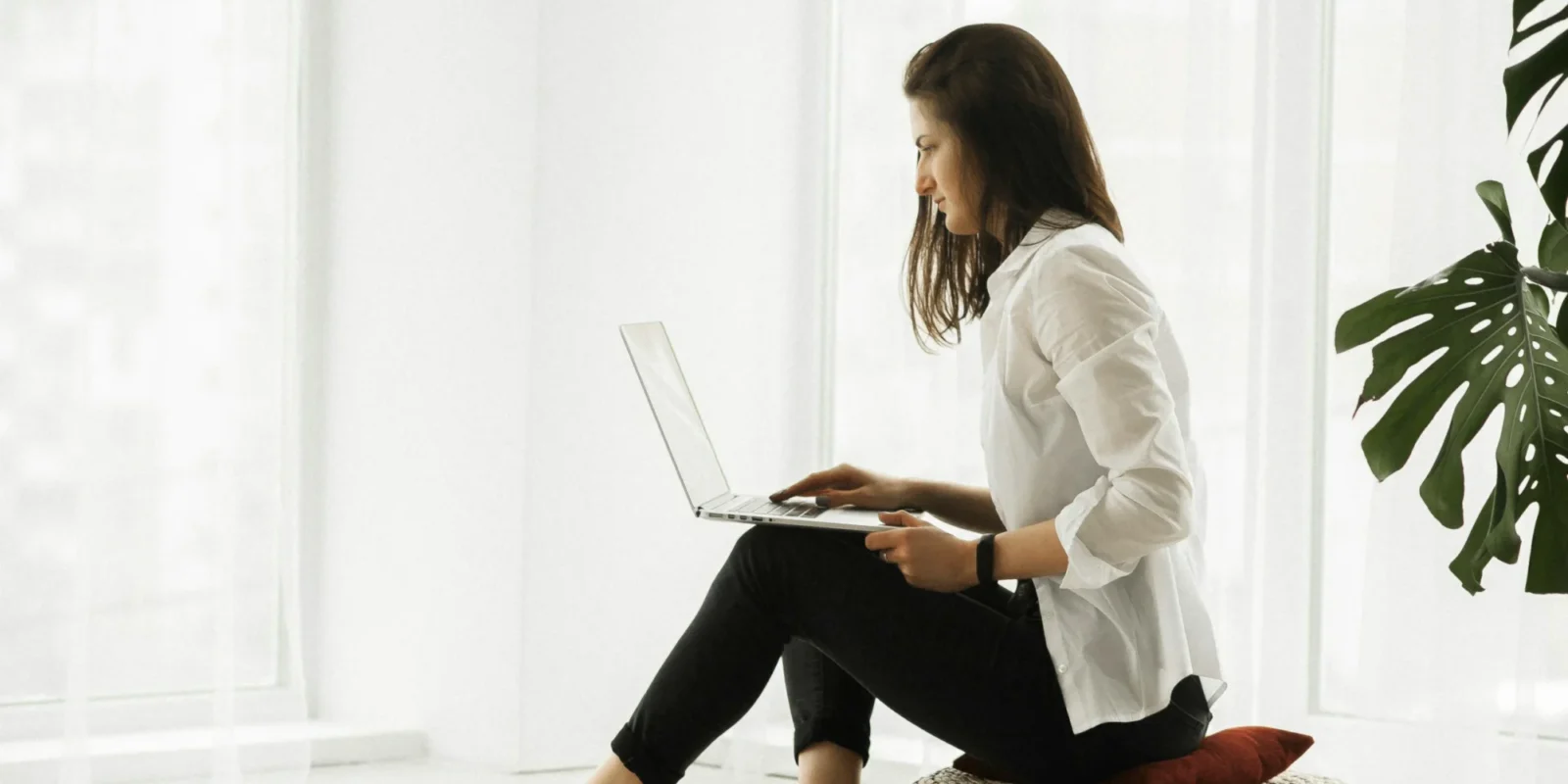 A woman sitting while on her computer.