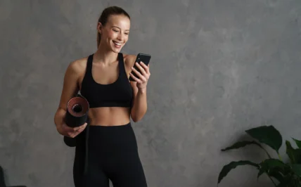 sporty woman looks at her phone
