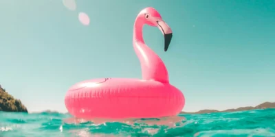 A pink flamingo float in a pool.