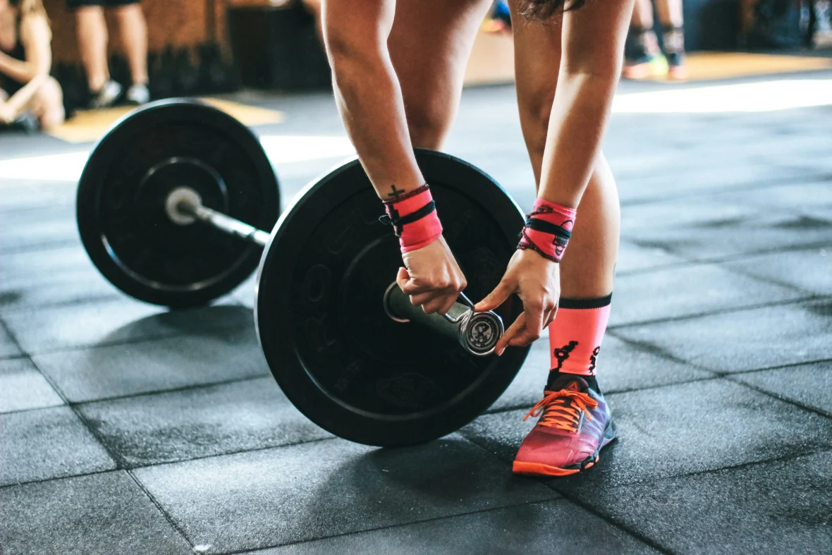 a woman securing weights / strength training