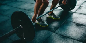person about to lift weighted barbell