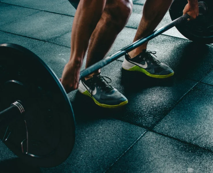 person about to lift weighted barbell