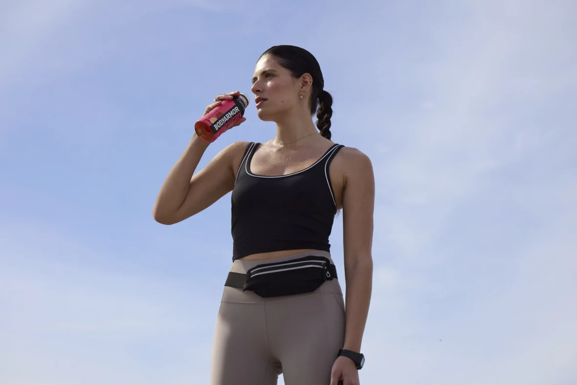 A female athlete drinking BodyArmor.