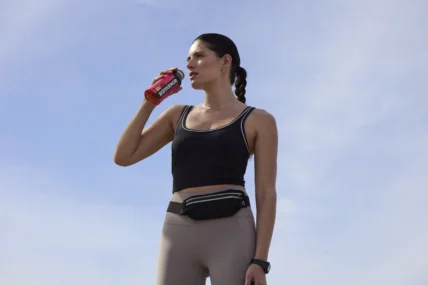 A female athlete drinking BodyArmor.