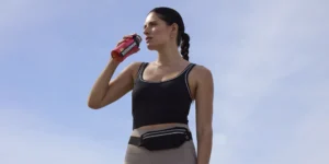 A female athlete drinking BodyArmor.
