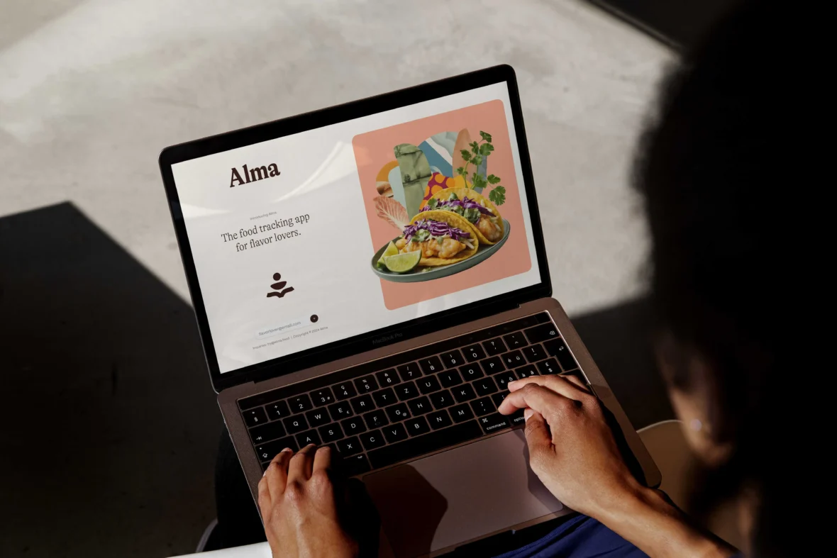 A laptop showing Alma's website.