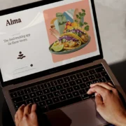 A laptop showing Alma's website.