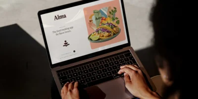 A laptop showing Alma's website.