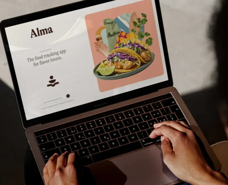 A laptop showing Alma's website.