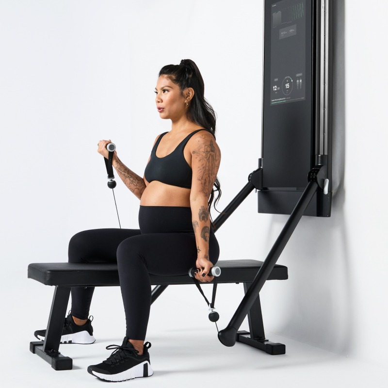 pregnant woman using Tonal exercise equipment