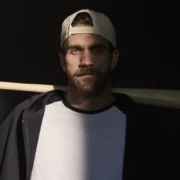 Bryce Harper holding a bat in the shadows.