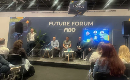 panelists speak on stage at a fitness industry event