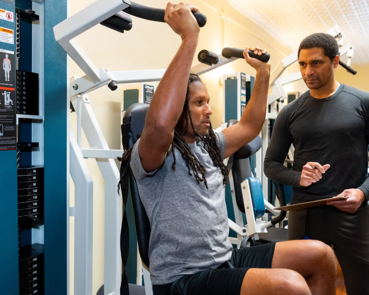 A client working out with a trainer at SlowBurn.