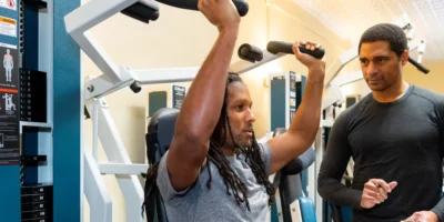 A client working out with a trainer at SlowBurn.