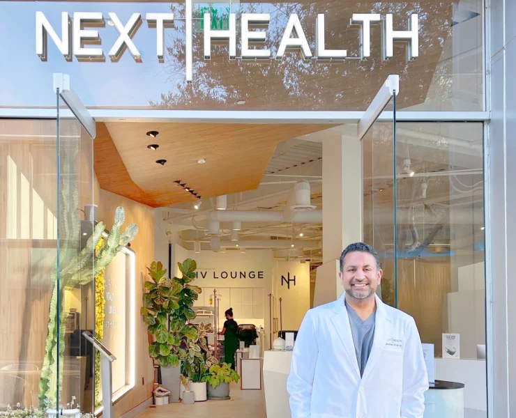 Dr. Darshan Shah poses in front of the Next Health entrance