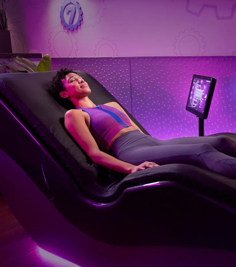 A woman relaxing at Planet Fitness in a HydroMassage lounger.