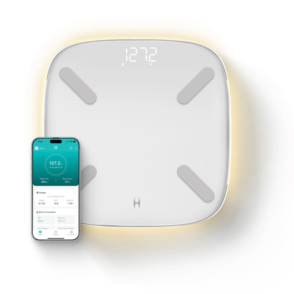 homedics smart scale in white with iPhone next to it