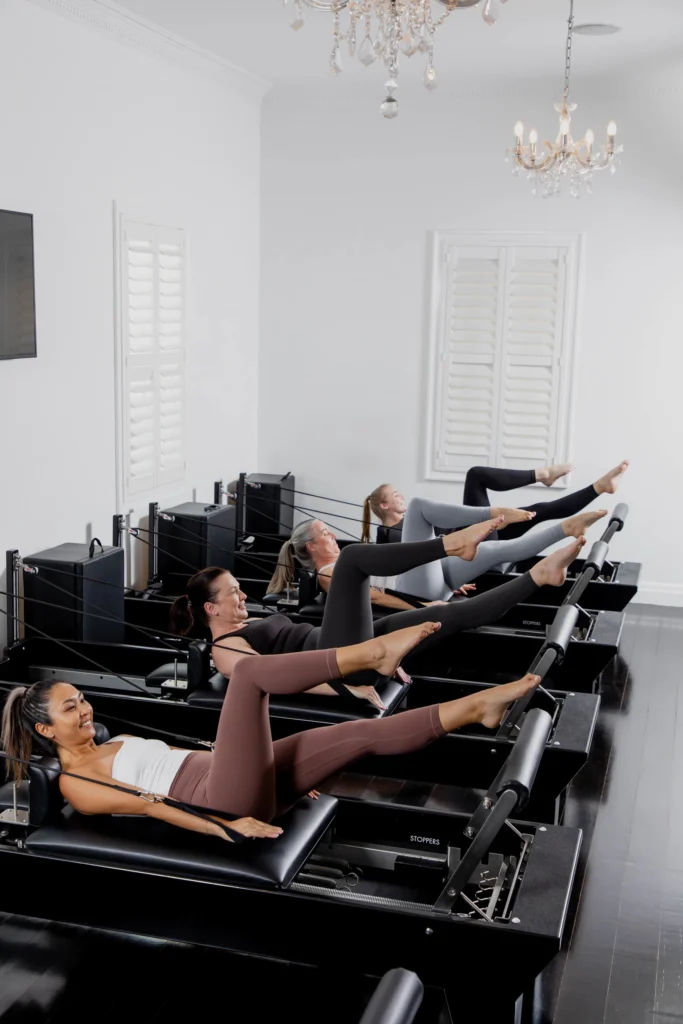 women clients at Studio Pilates using Reformer machines.