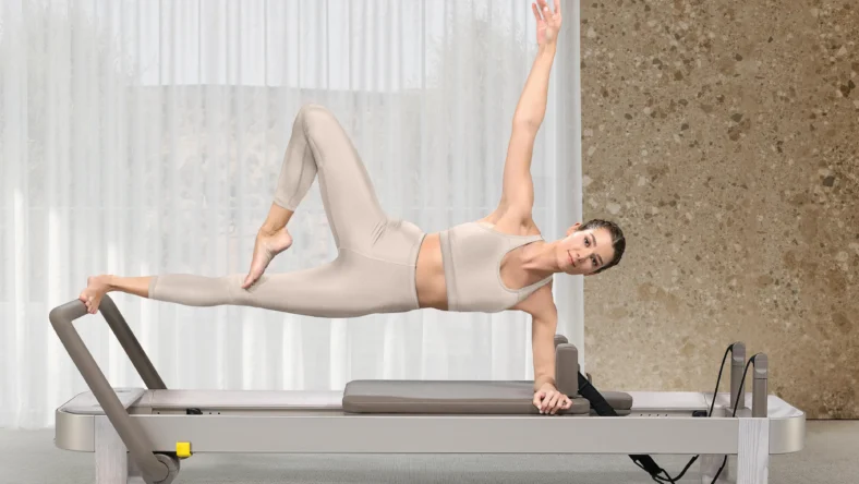 A woman on a new Technogym Reform, a Pilates Reformer.