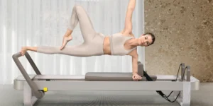 A woman on a new Technogym Reform, a Pilates Reformer.