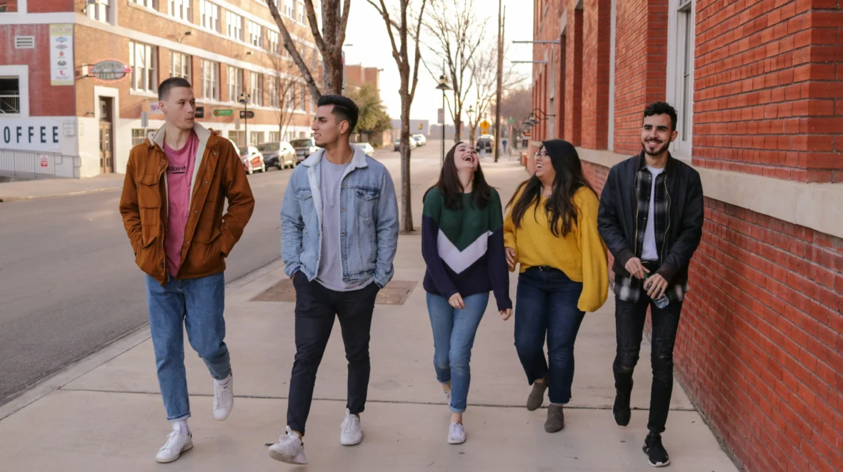 A group of young people walking down the street.
