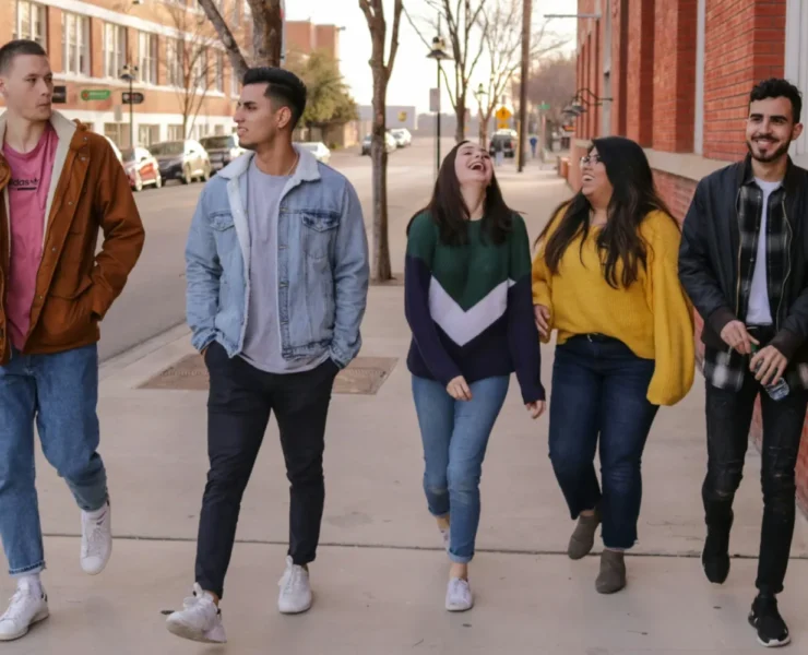 A group of young people walking down the street.
