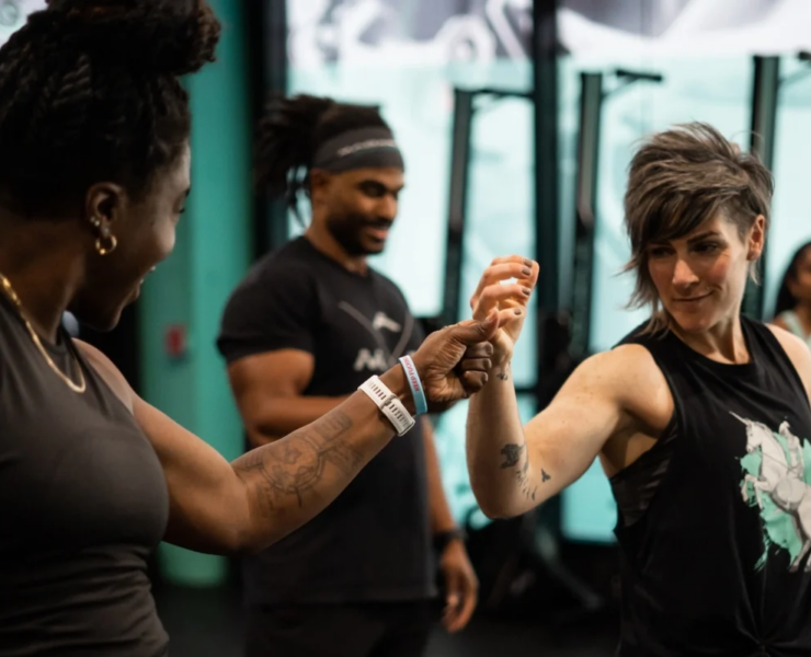 man and woman at gym first bump
