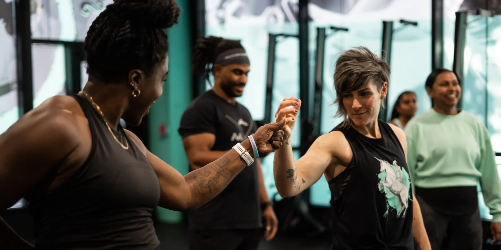 man and woman at gym first bump