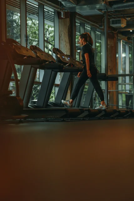 A woman walking on a treadmill.