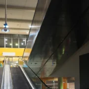 an empty shopping mall with empty escalators.