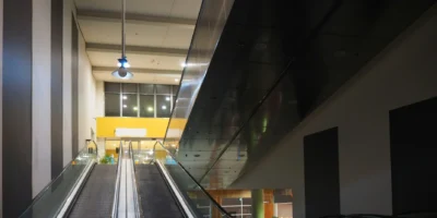 an empty shopping mall with empty escalators.