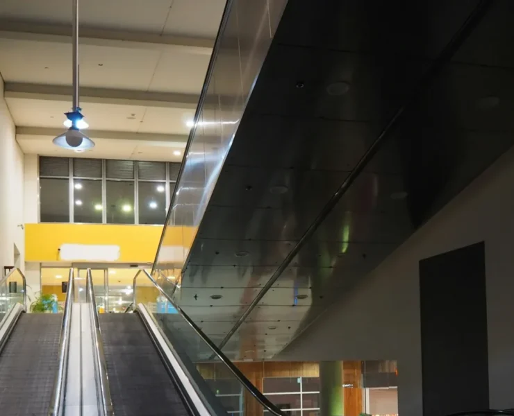 an empty shopping mall with empty escalators.