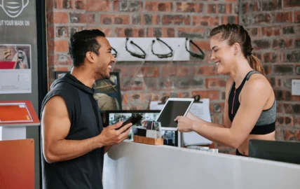 woman checks man into a gym