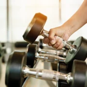 man holds a dumbbell