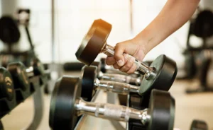man holds a dumbbell
