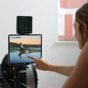 A woman using the new rowing content from Fitness On Demand.