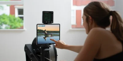 A woman using the new rowing content from Fitness On Demand.