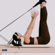 A woman using a Reformer.