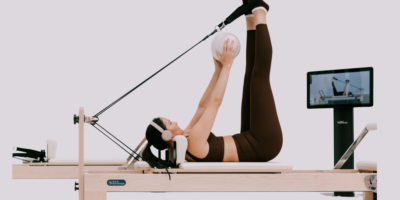A woman using a Reformer.