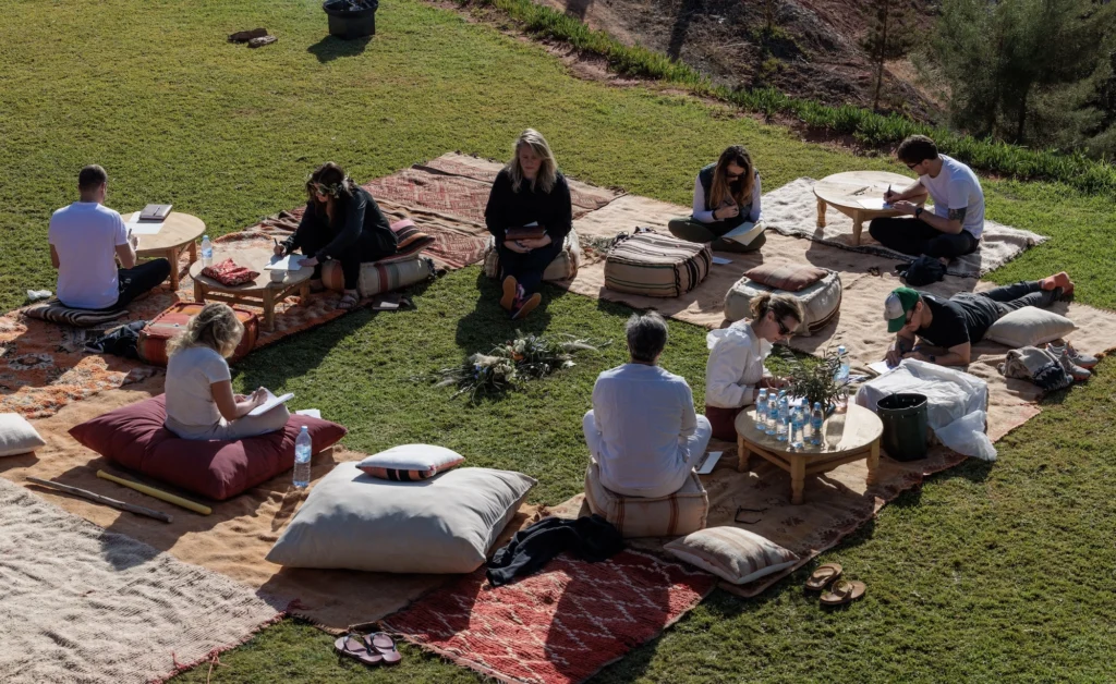 People gather during an outdoor retreat in nature