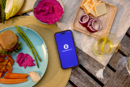 A phone sitting on a table with the WeightWatchers app loaded.