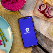 A phone sitting on a table with the WeightWatchers app loaded.