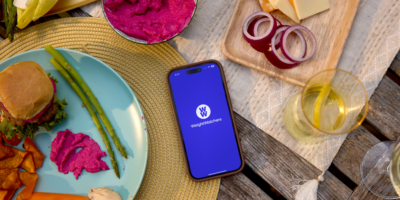 A phone sitting on a table with the WeightWatchers app loaded.