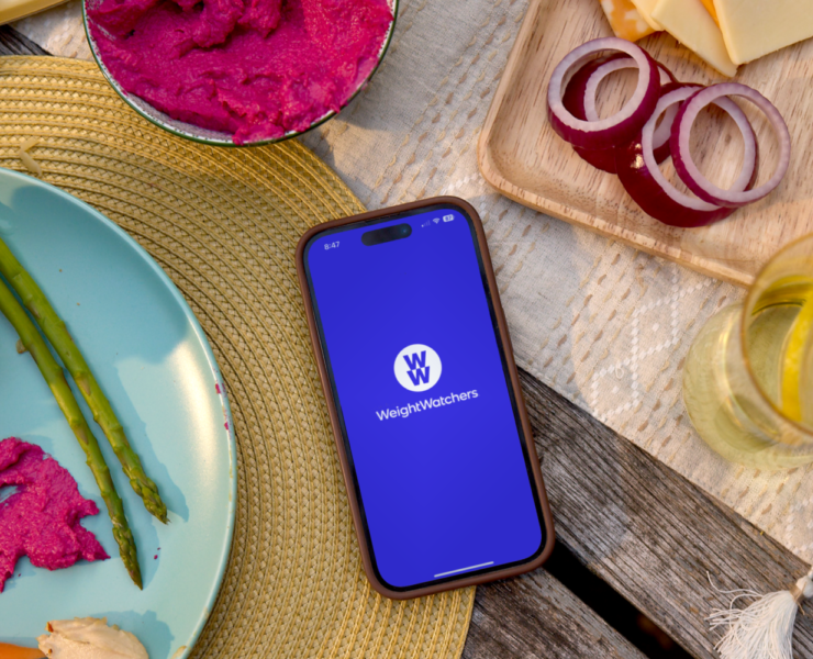 A phone sitting on a table with the WeightWatchers app loaded.