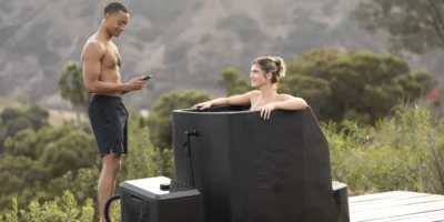A woman in an Ice Barrel outdoors with a man.
