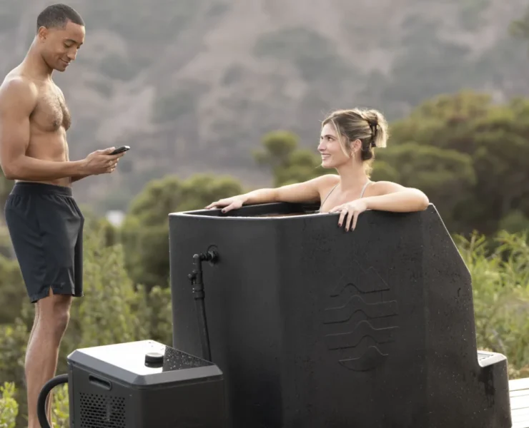 A woman in an Ice Barrel outdoors with a man.